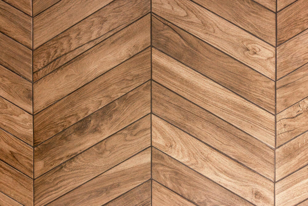 A close-up of chevron patterned wood flooring.