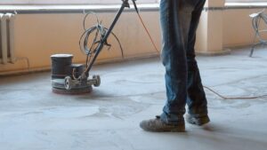 using a concrete grinding machine on a bare floor